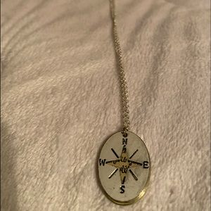 A compass necklace with quote